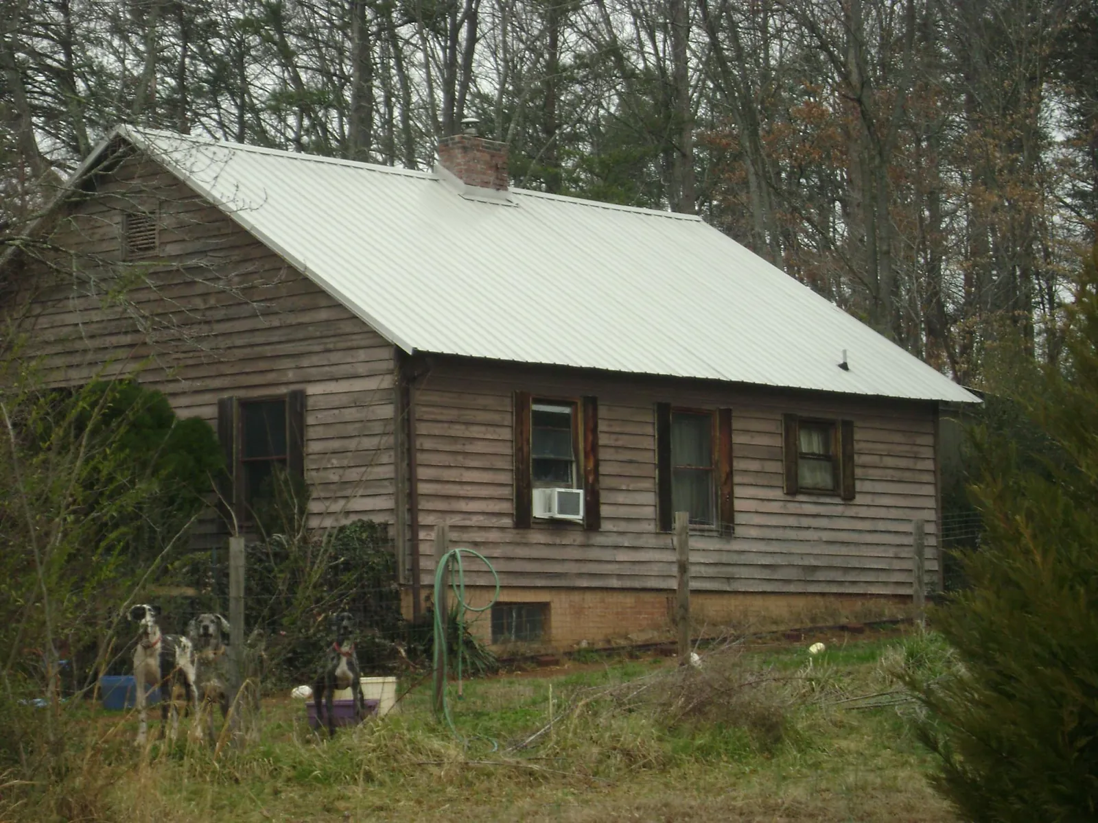 White metal roof on an old wood sided farmhouse, from a Metal Roof Installation job in Leverett